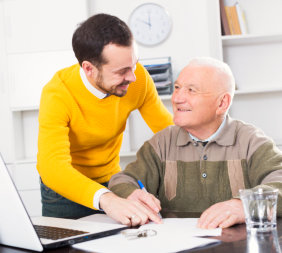 senior woman writing with a man on his left