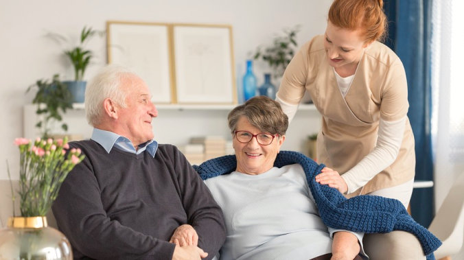 caregiver taking care of senior couple