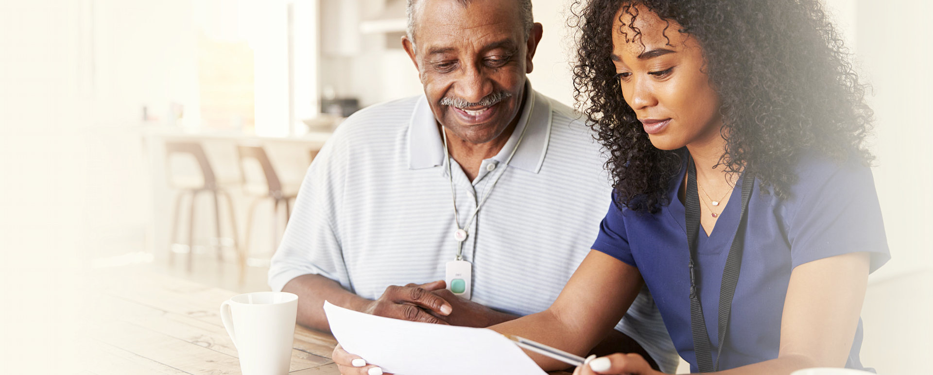 caregiver and senior man reading