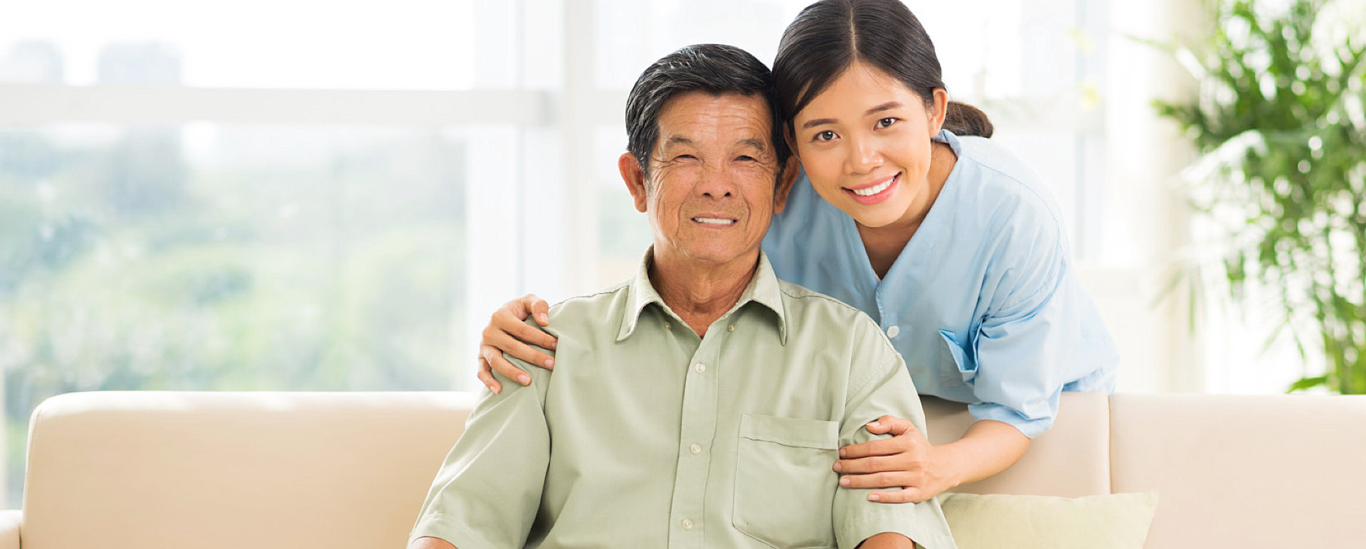 caregiver hugging senior man