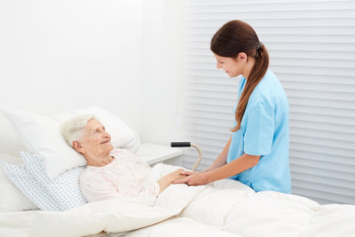 senior woman and female caregiver looking at each other