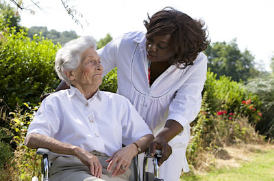 senior woman and female caregiver looking at each other