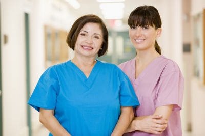 two female caregivers smiling