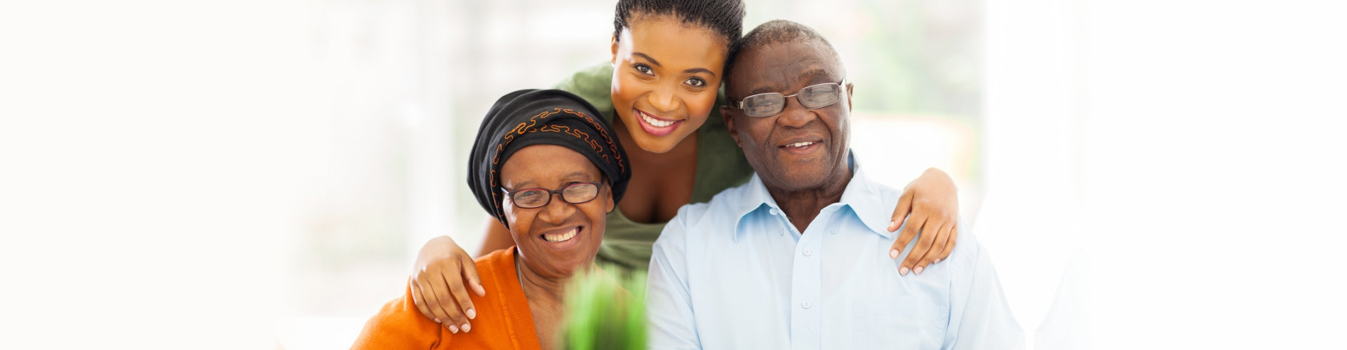 senior couple and female caregiver smiling